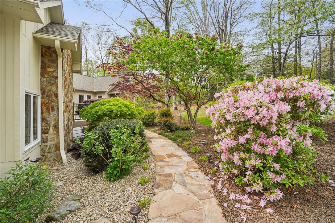 Image 2: A stone pathway leads to a beautiful residence sur