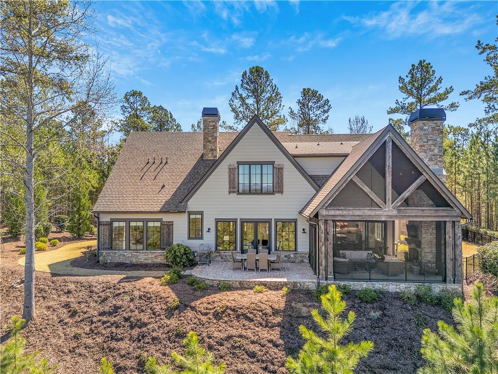 Image 2: This beautiful residence features a screened porch
