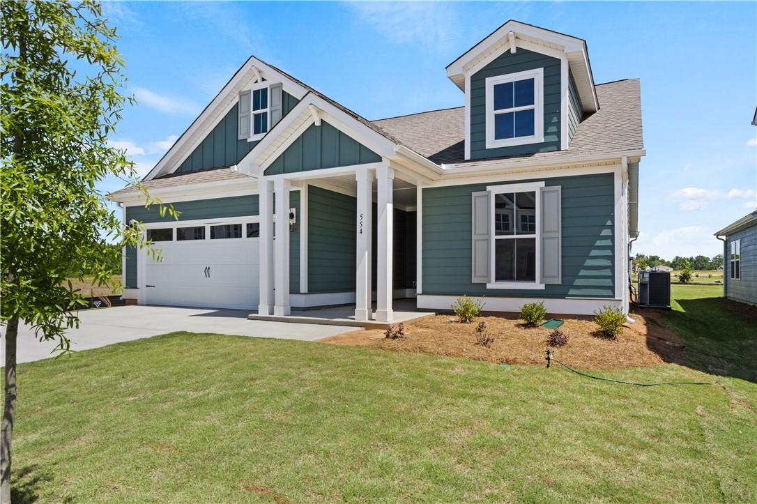 Image 2: A well-maintained lawn welcomes you to this inviti