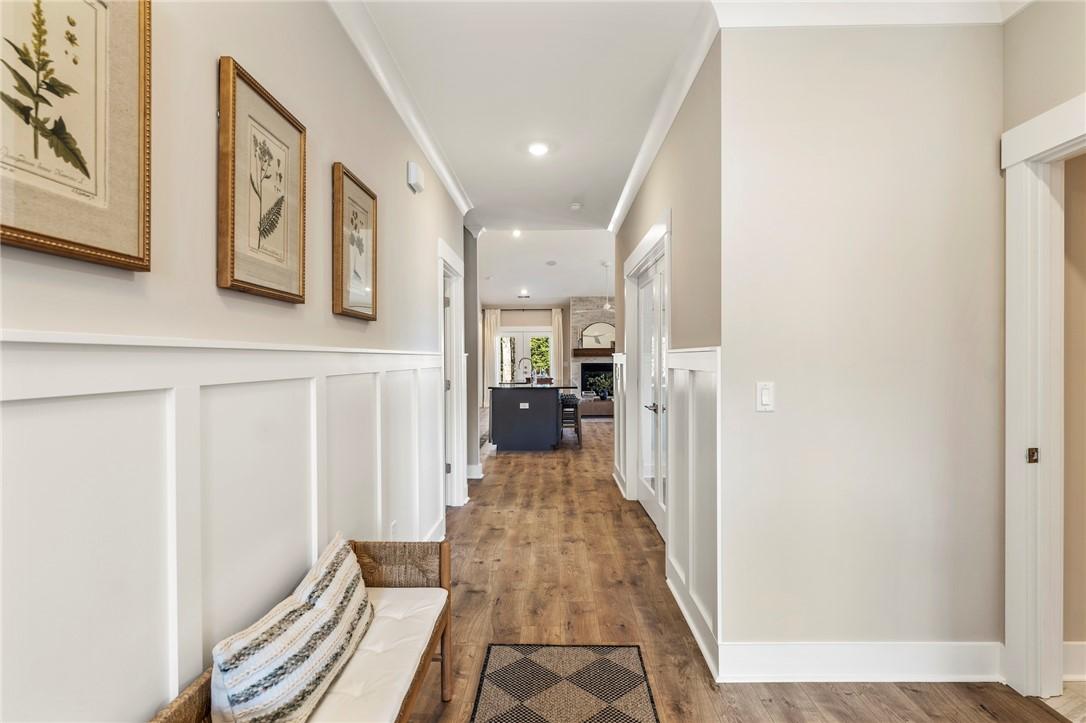 Image 2: This inviting hallway features wainscoting and war