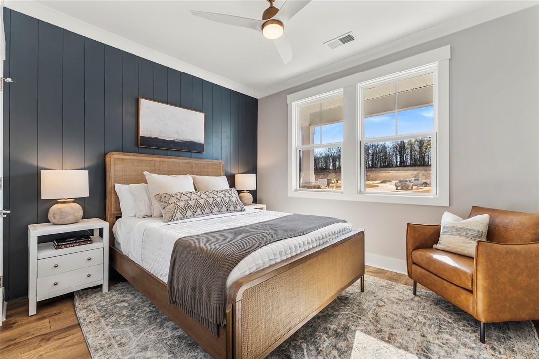 Image 4: This spacious bedroom offers ample natural light a