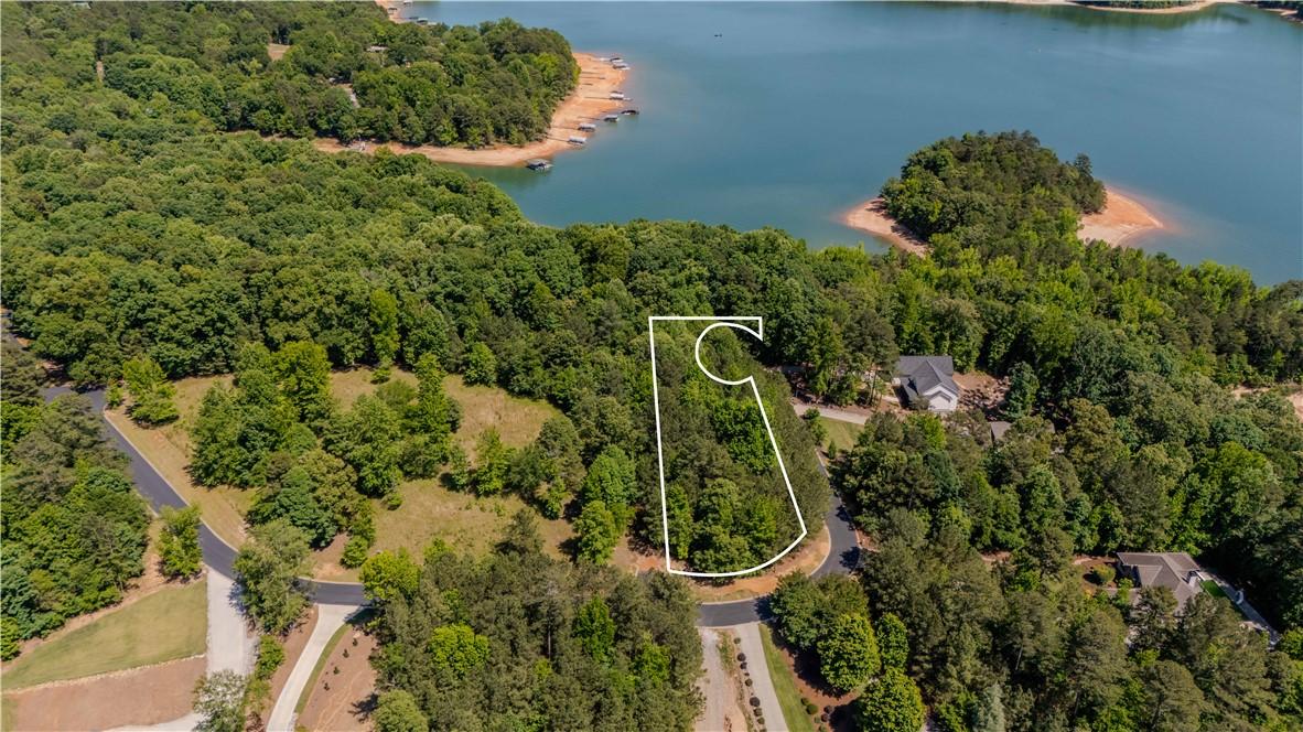 Image 1: This tranquil waterfront lot provides a verdant ca