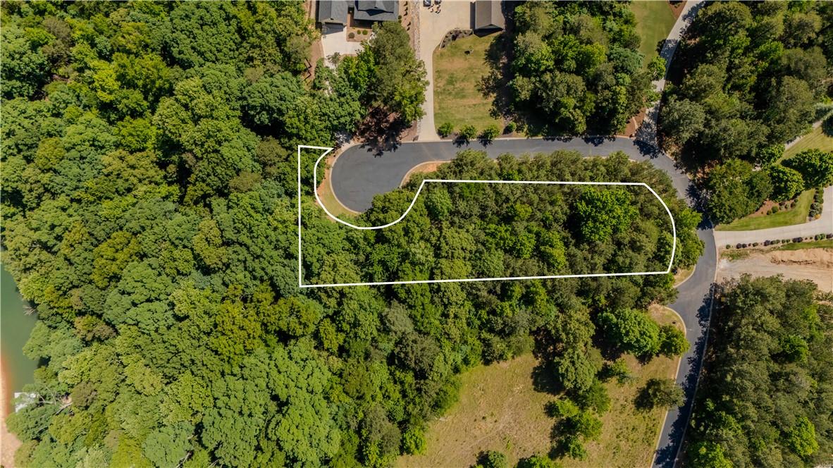 Image 2: A verdant, expansive parcel offers a private setti