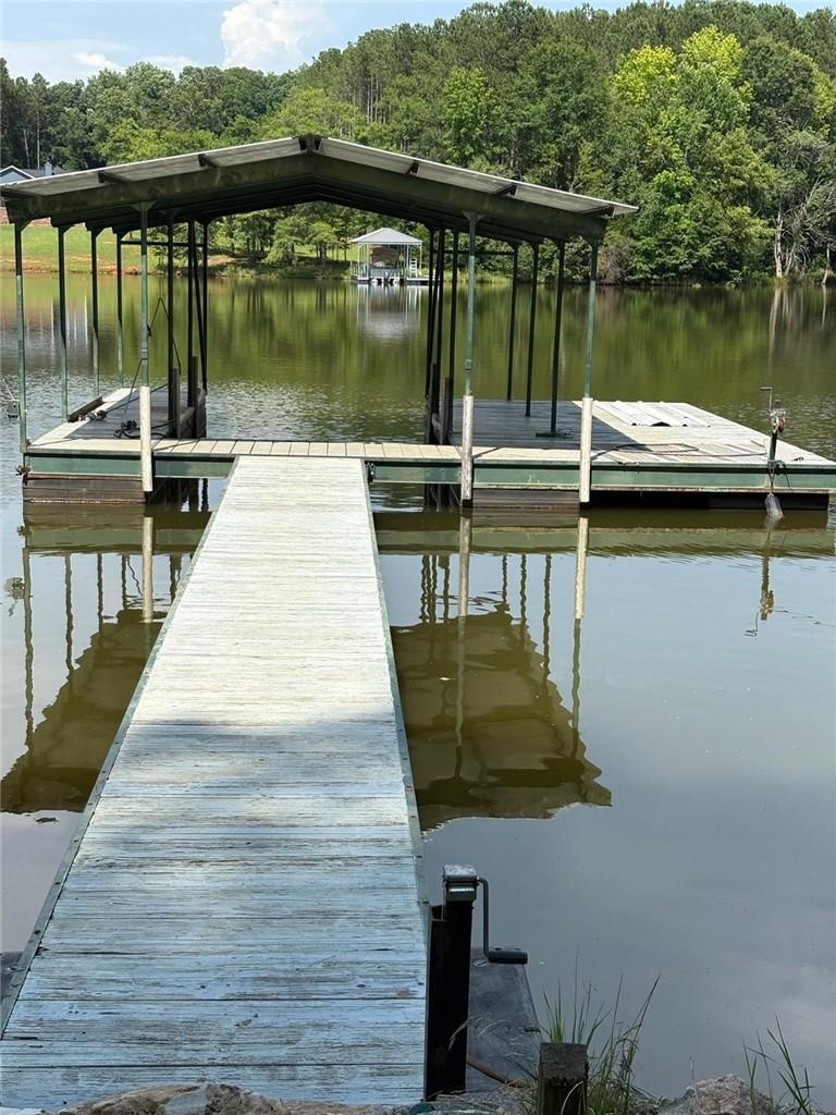 Image 2: Boathouse with covered slips provides direct acces