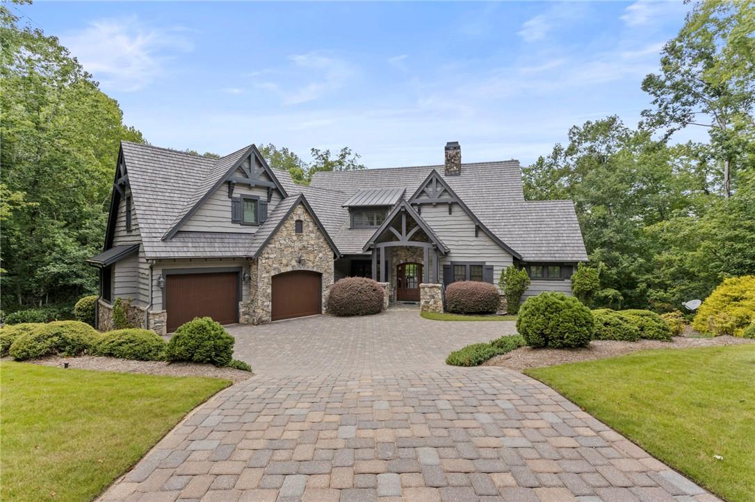 Image 1: A charming Craftsman-style residence boasts a pave
