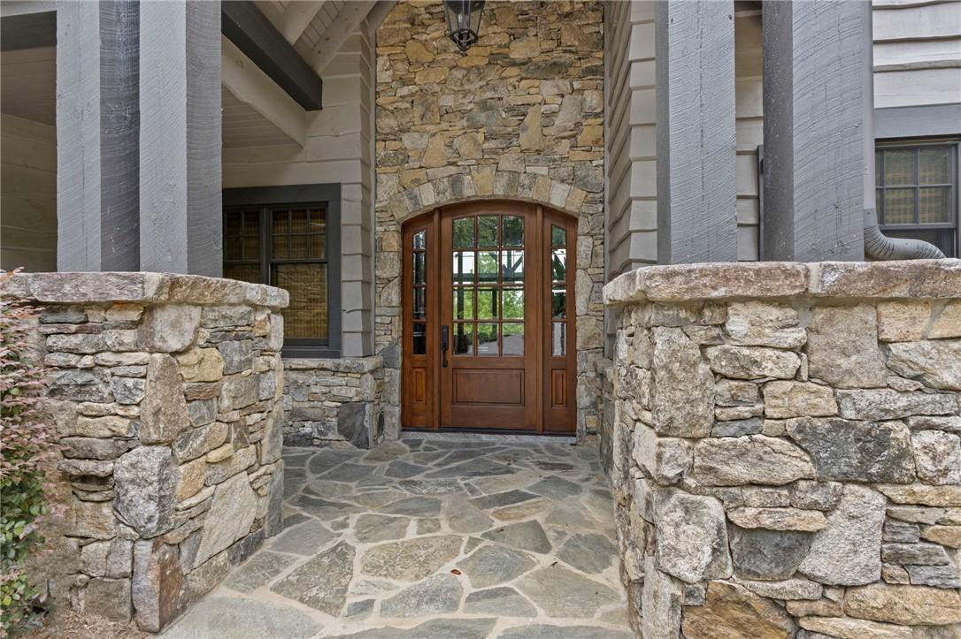 Image 2: A robust stone and timber entrance leads to a soli