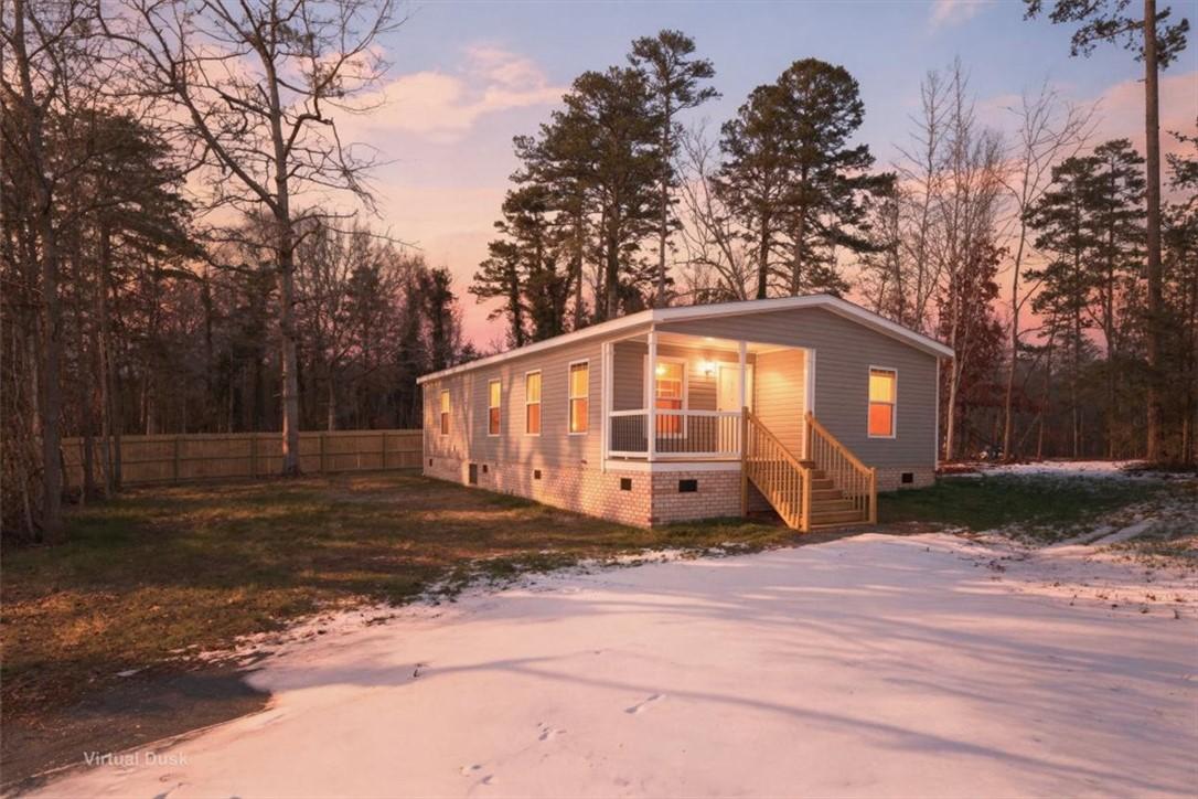 Image 1: This charming home offers comfortable living with