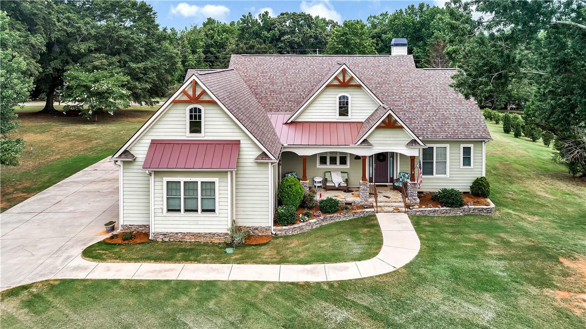 Image 1: A charming residence with inviting curb appeal, fe