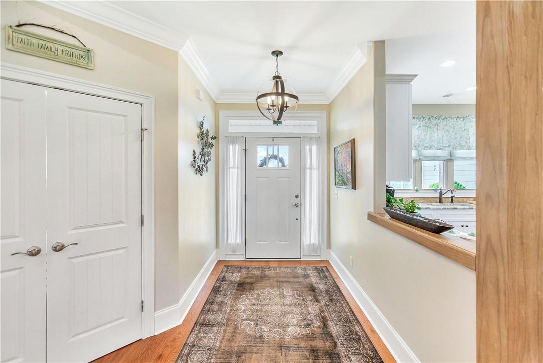 Image 2: A graceful entry hall welcomes, showcasing hardwoo