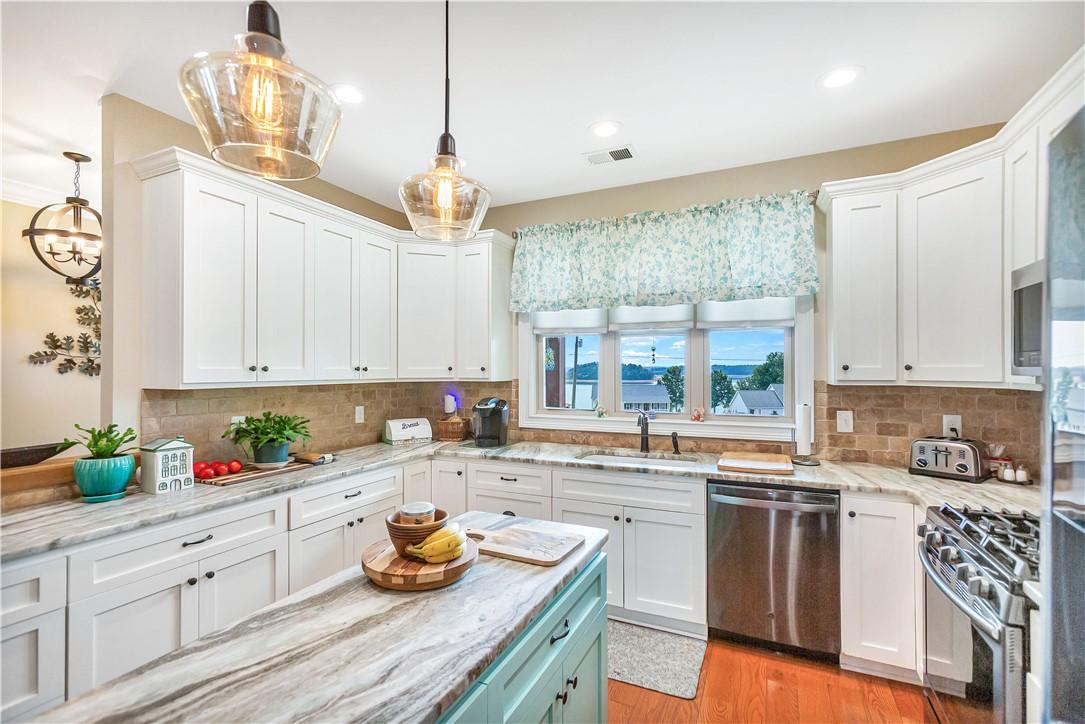 Image 3: Bright, airy kitchen with pristine white cabinetry