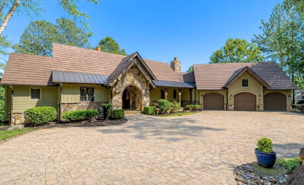 Image 2: This charming home offers a sprawling paver drivew