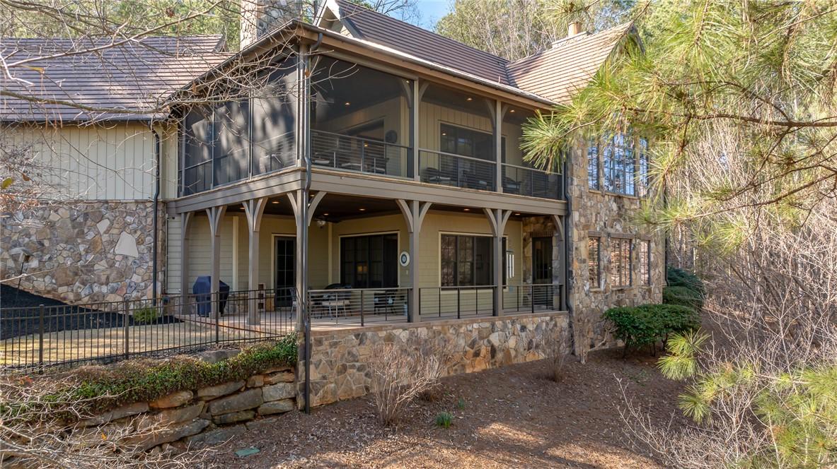 Image 3: This charming residence features screened porches,