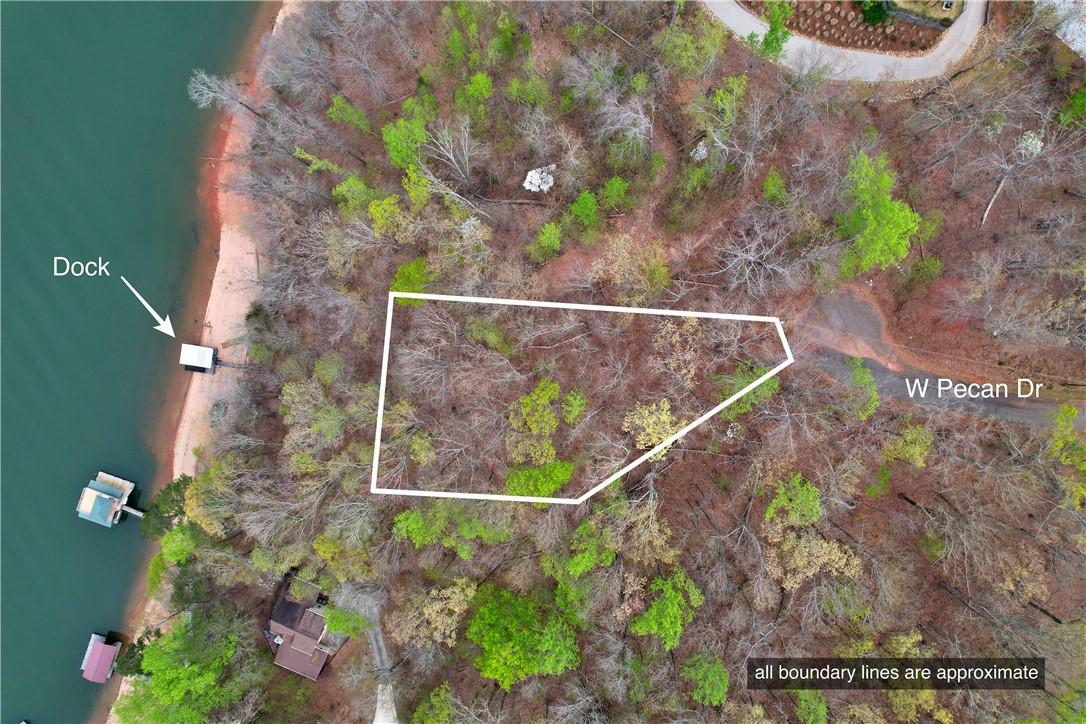Image 1: This aerial view showcases a waterfront lot with m