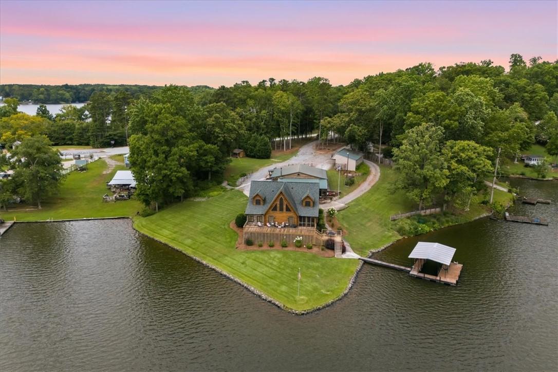 Image 1: Perched on the lake's edge, a charming home awaits