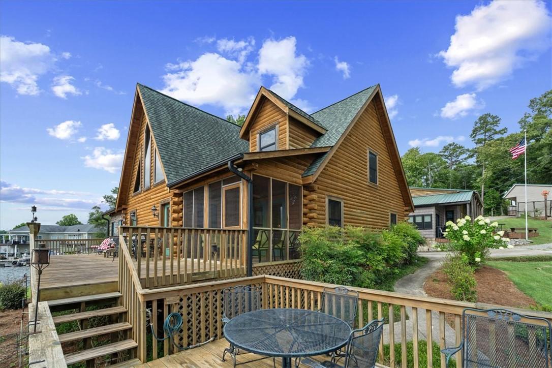 Image 2: A charming log cabin with a spacious wooden deck o