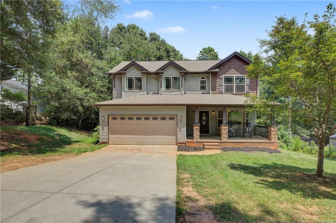 Image 1: A well-maintained two-story residence with a cover