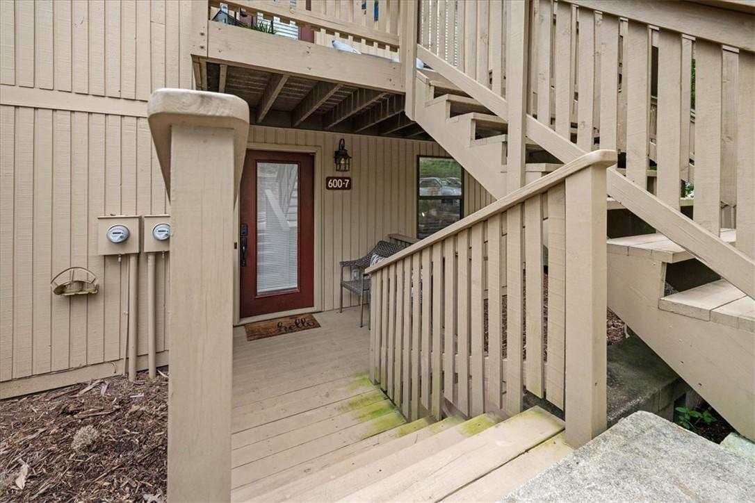 Image 2: A welcoming front entry with a warm red door, offe