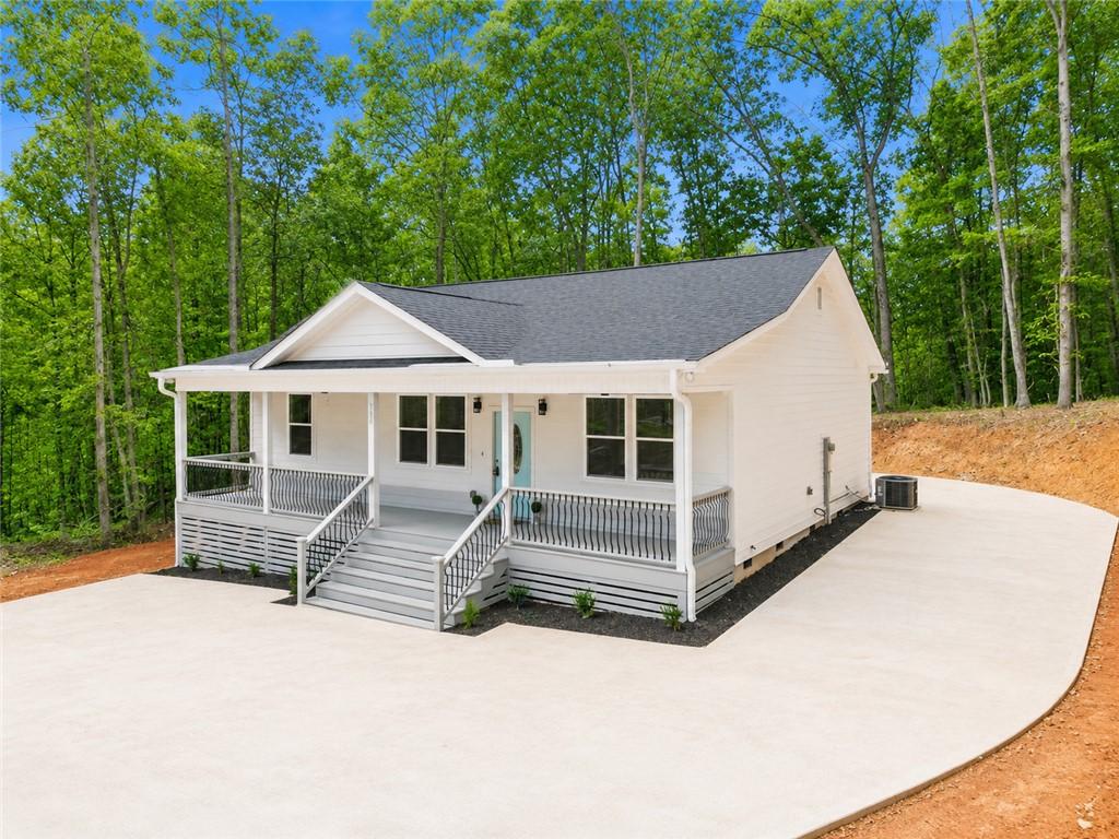Image 3: A welcoming front porch with white siding and gray