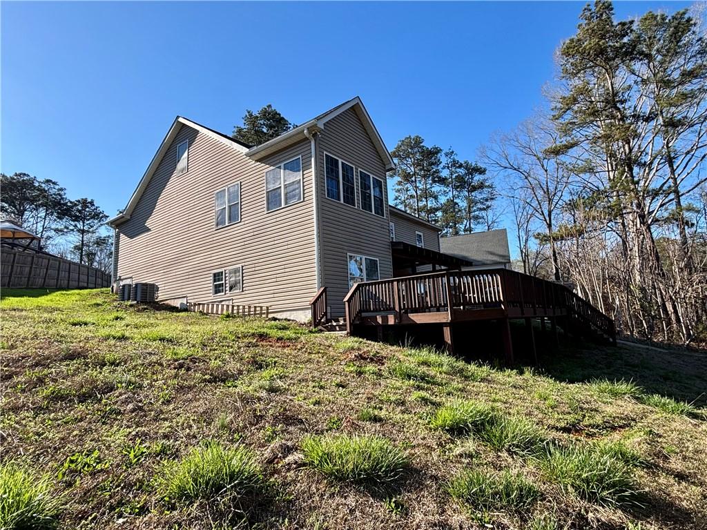 Image 3: This residence features a spacious deck and ample
