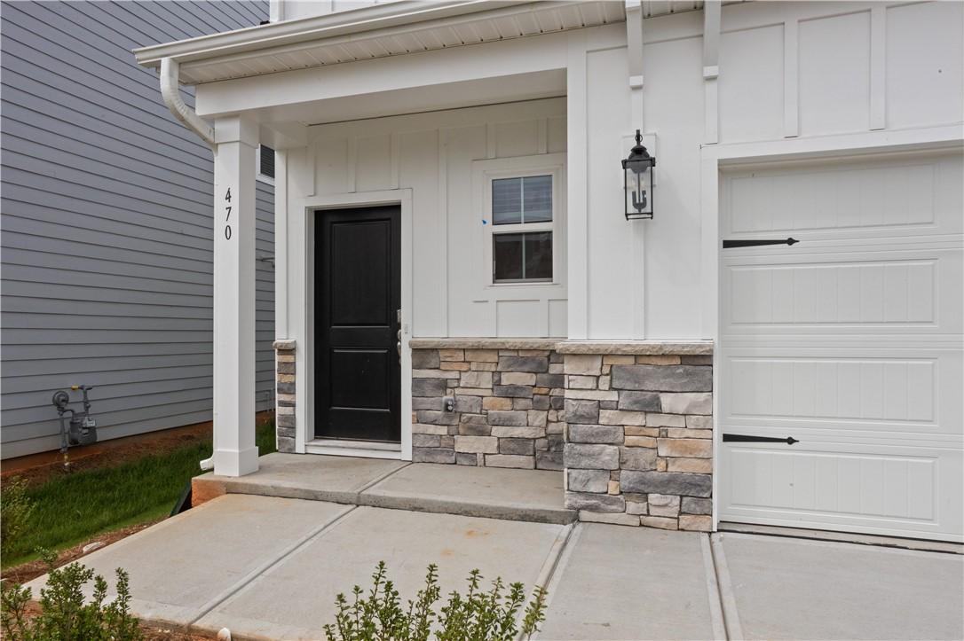 Image 3: A welcoming entry featuring stone veneer and clean