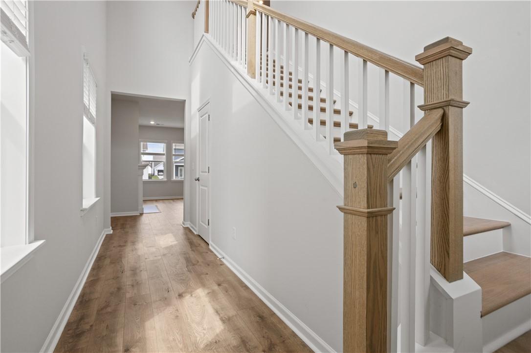 Image 4: A graceful staircase with warm wood accents leads