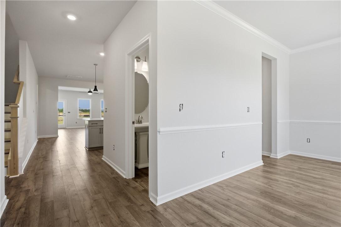 Image 4: Rich hardwood floors lead to a sun-drenched kitche