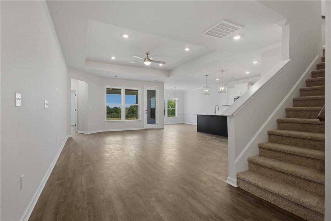 Image 4: An airy great room welcomes with wood-style floori