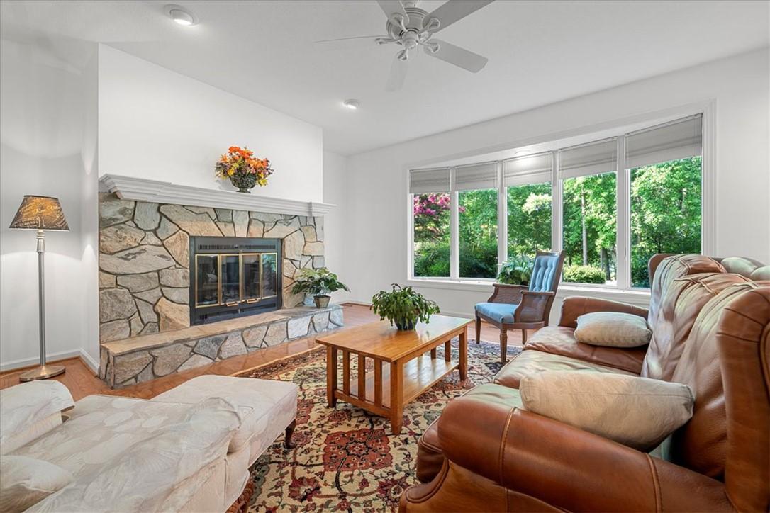 Image 1: This inviting living room features a stately stone