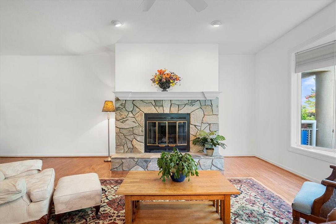 Image 2: This inviting living area features a grand stone f
