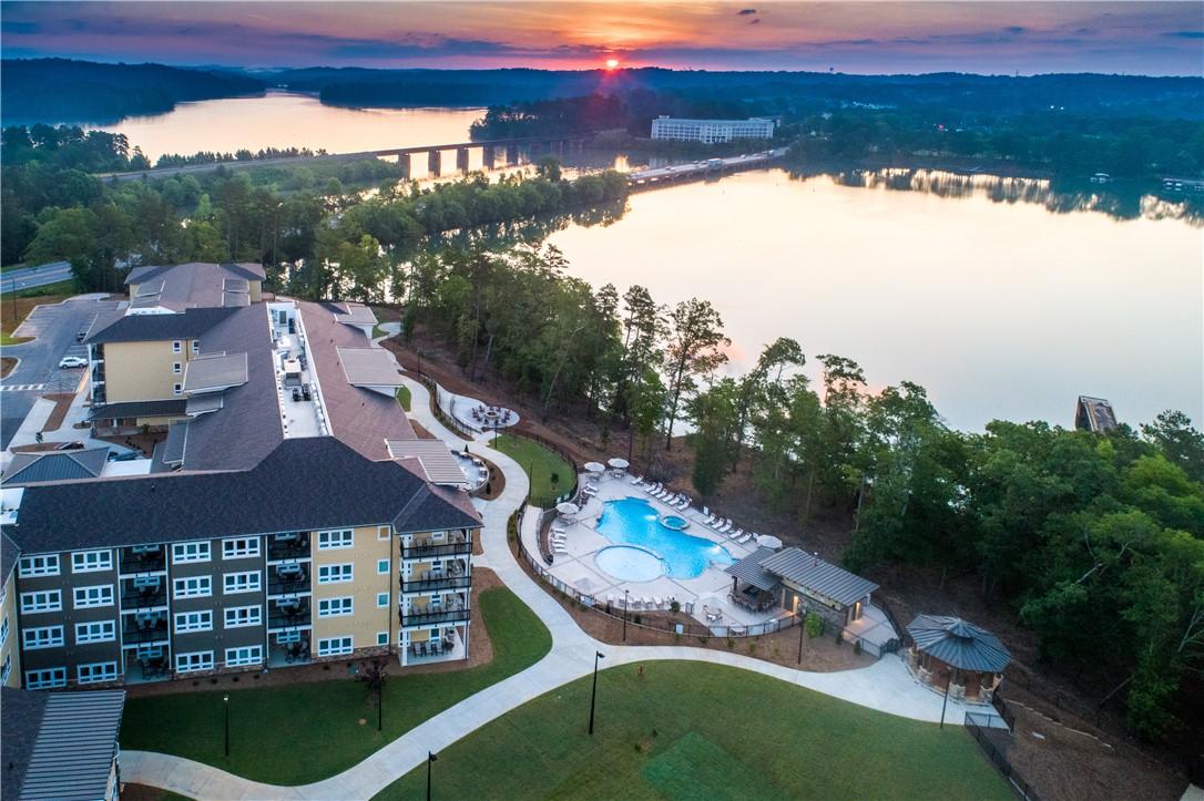 Image 1: Perched above a serene lake, this community boasts