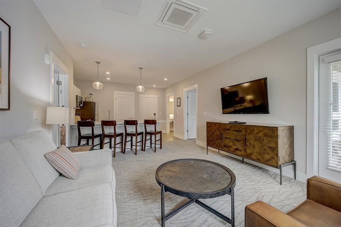 Image 3: An inviting open-concept living space features sty