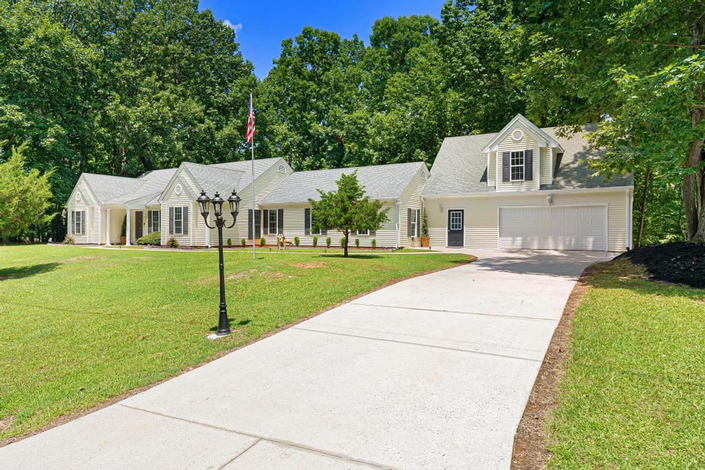 Image 3: A graceful home with a welcoming driveway leads to