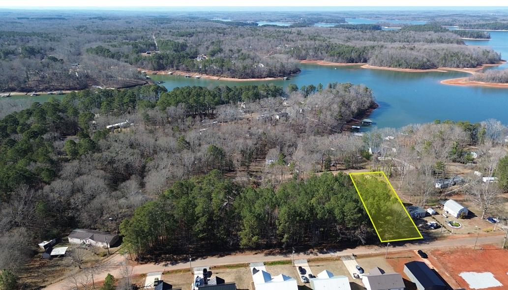 Image 1: This aerial view showcases a desirable lot with be