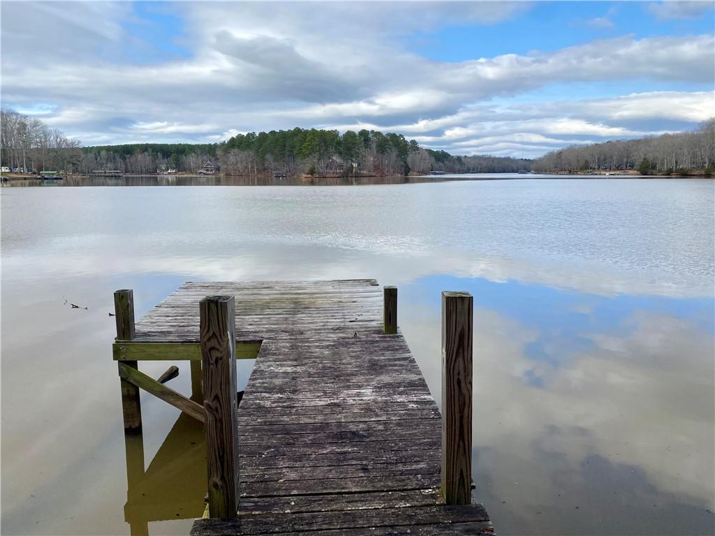 Image 4: A tranquil lake view with a private pier extending