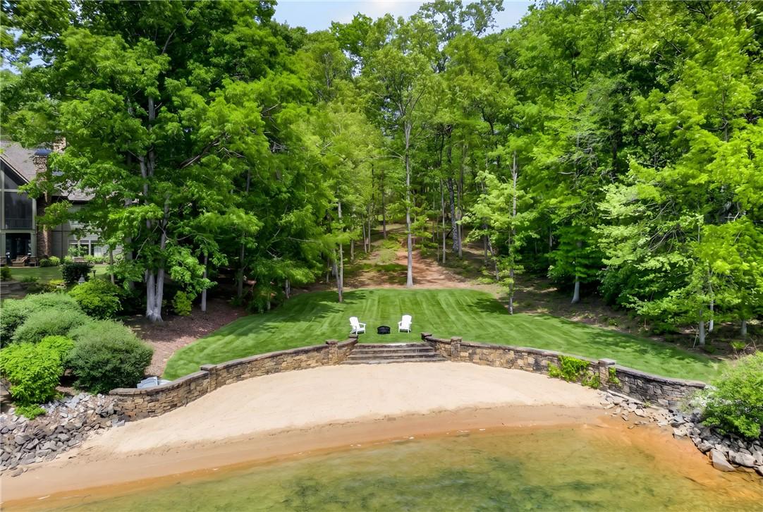 Image 4: This serene lakefront property offers a private be