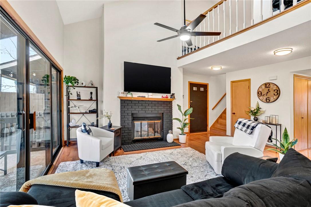 Image 2: This living room features high ceilings and a cozy
