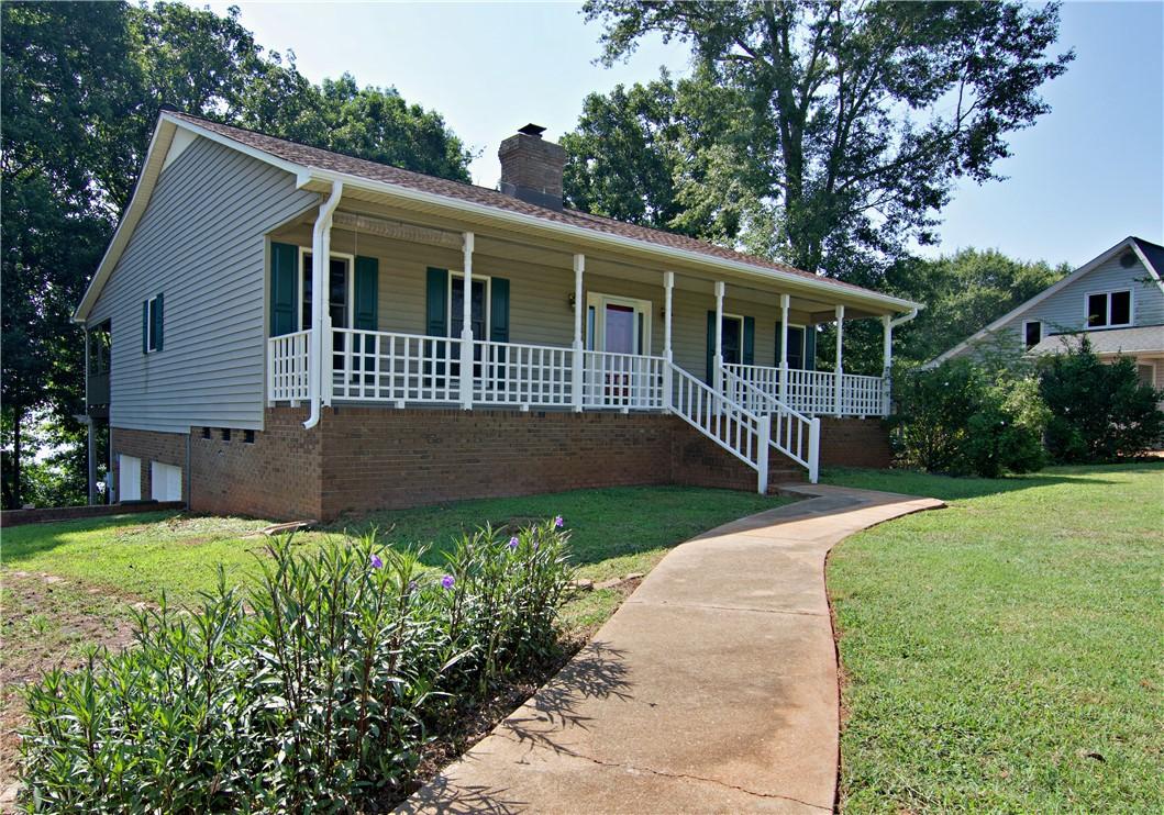 Image 4: A charming ranch home with a wide covered front po