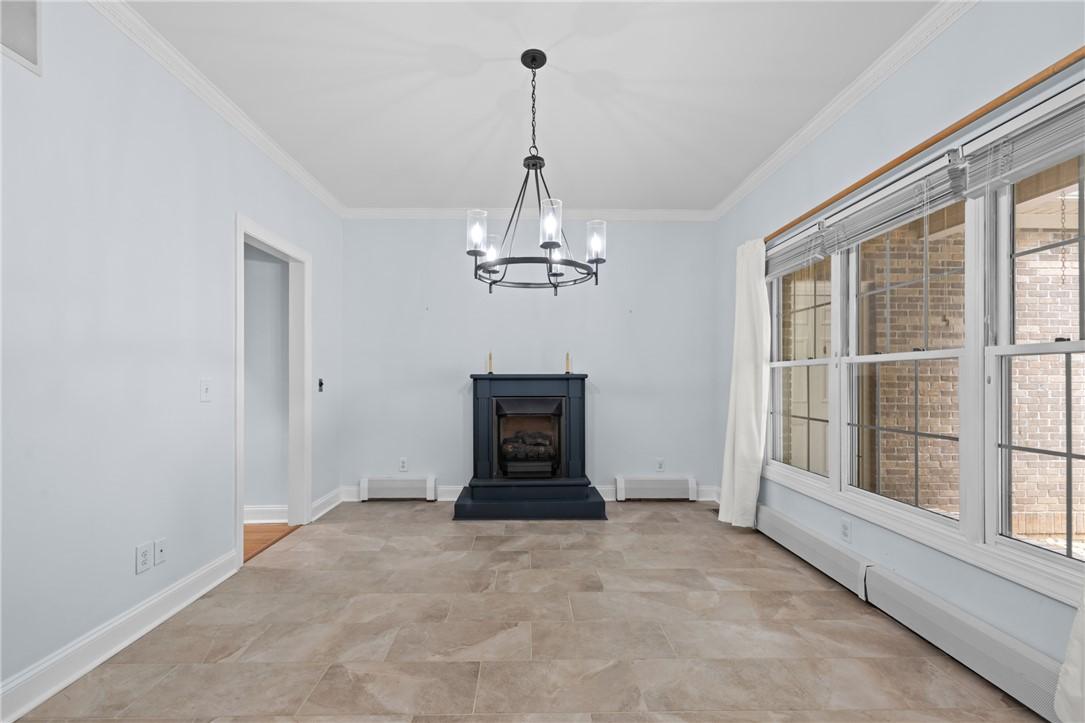 Image 3: An inviting dining area offers a fireplace, tile f