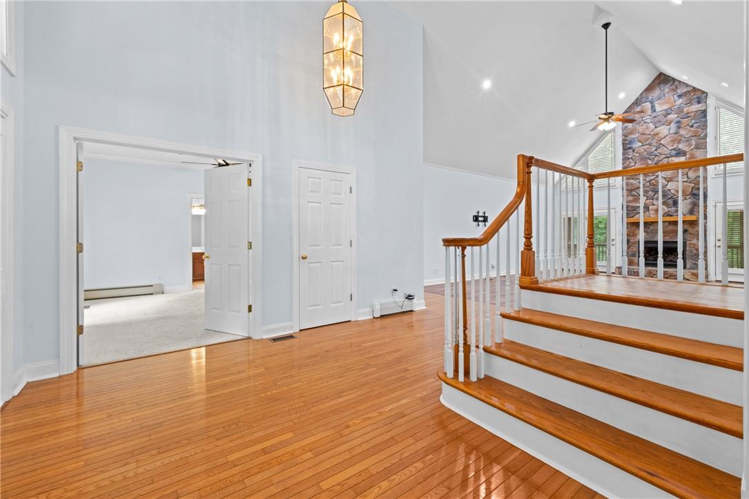 Image 4: A grand entrance with gleaming hardwood floors wel