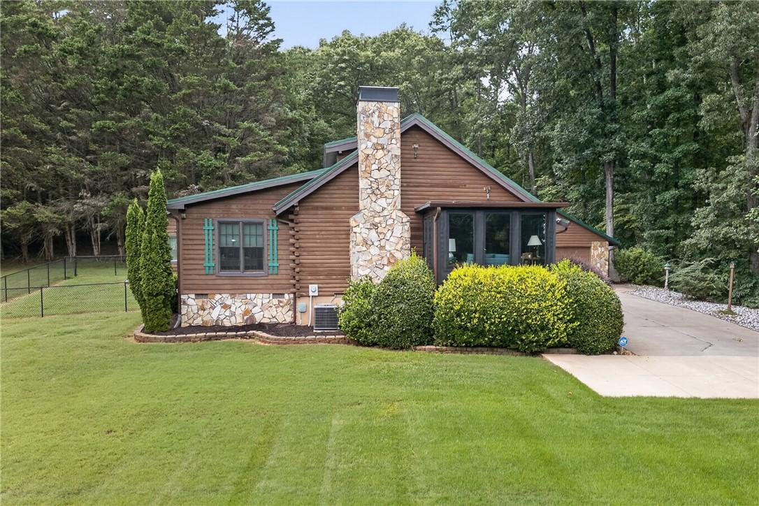 Image 2: A rustic log cabin, nestled amongst verdant trees,