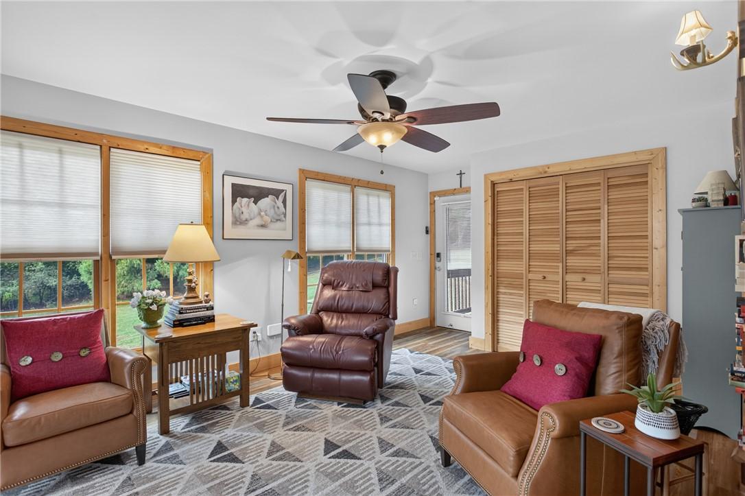 Image 4: A comforting living space features ample natural l