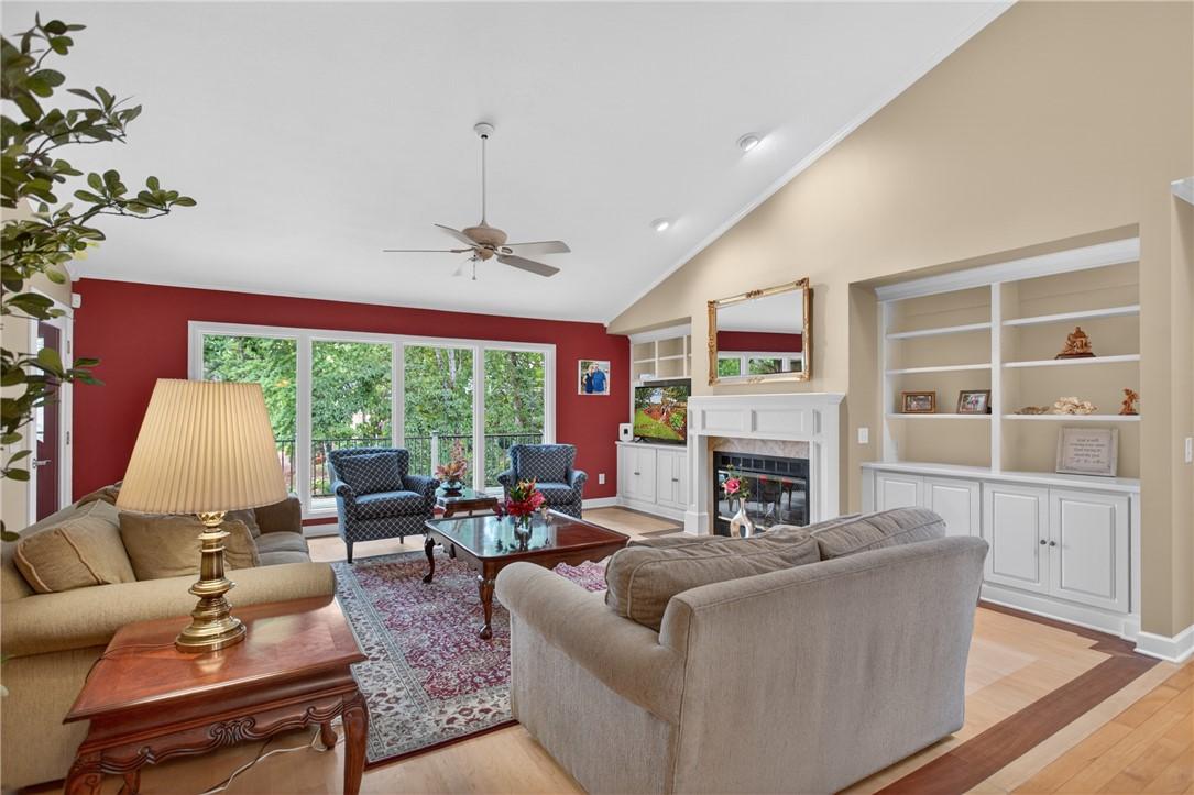 Image 3: A living area with soaring vaulted ceilings and la