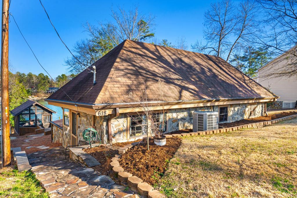 Image 3: This charming lakeside dwelling features a unique