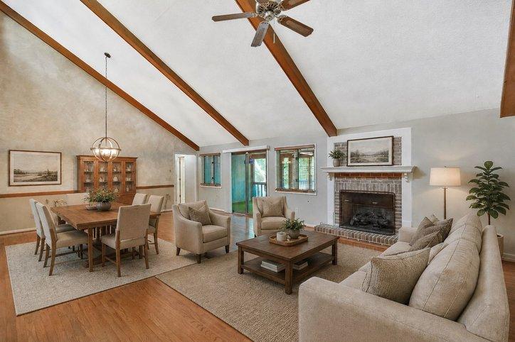 Image 3: Vaulted ceilings and warm wood floors define this
