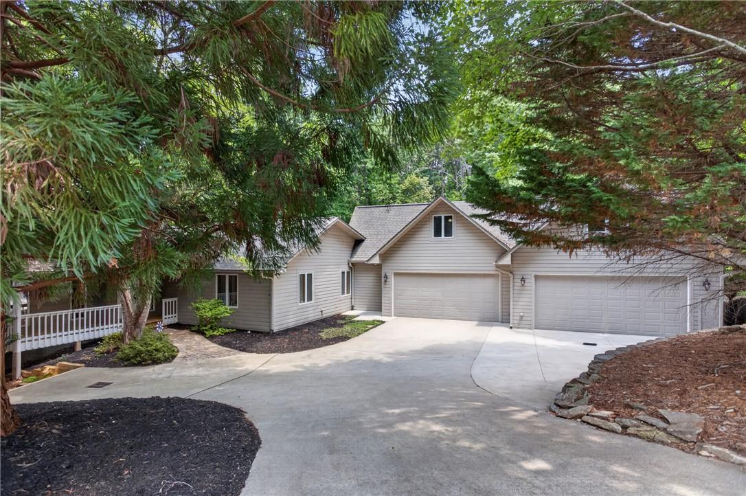 Image 1: A spacious home nestled amidst lush greenery, feat
