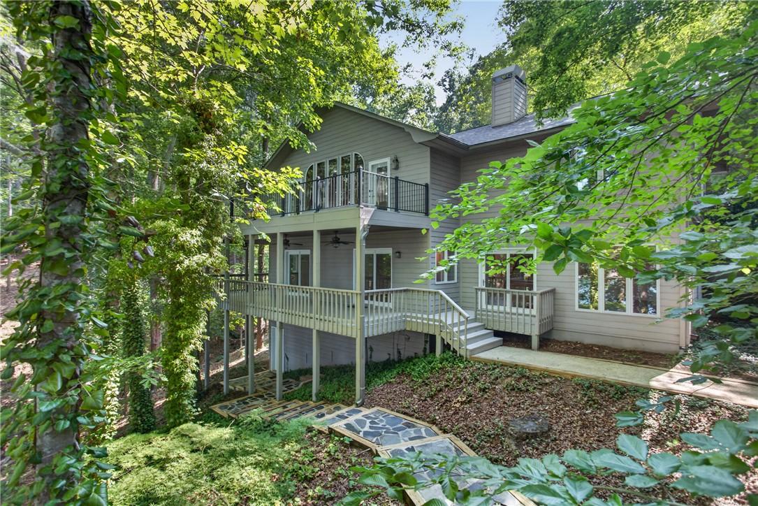 Image 2: Perched among the trees, this multi-level home fea