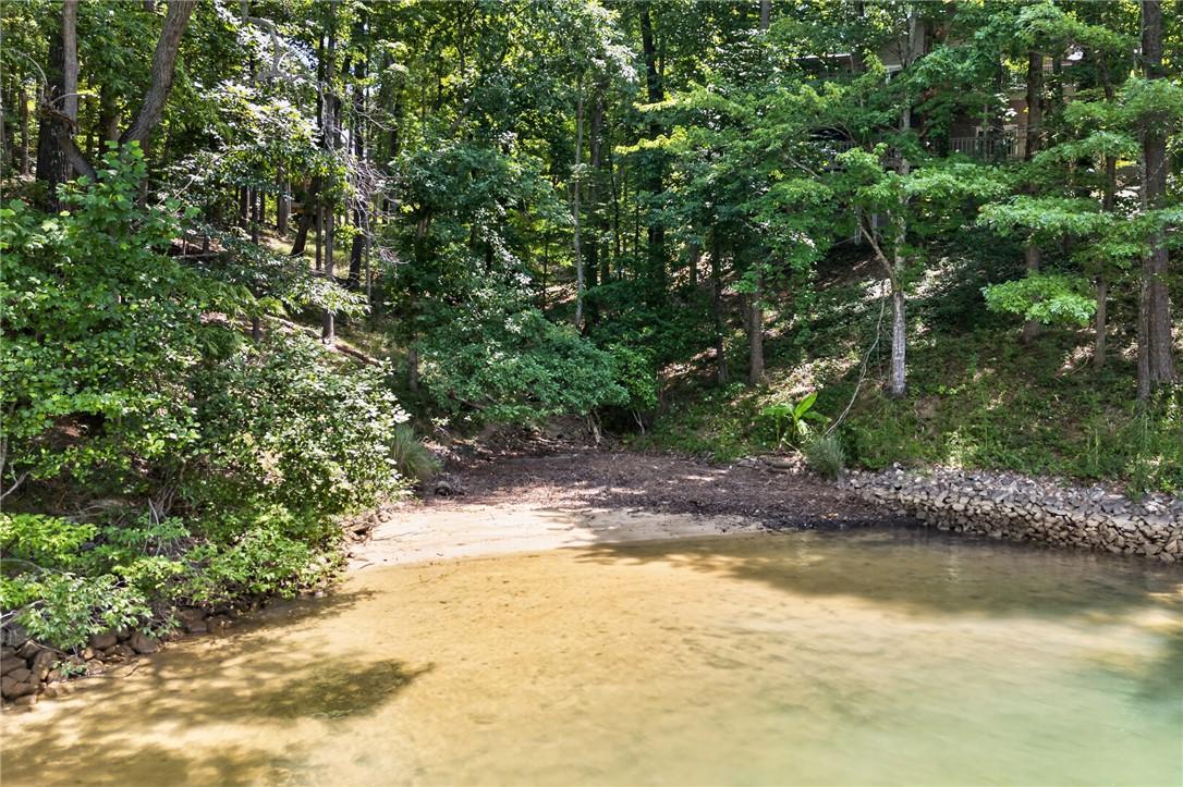 Image 4: Natural sand beach completes this quiet cove.