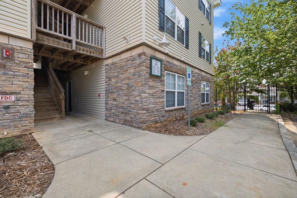 Image 1: A corner unit with stone and siding exterior offer