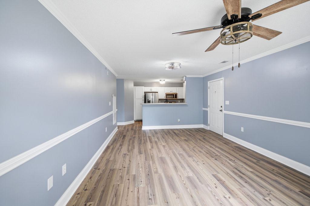 Image 4: An open concept living space features light wood f