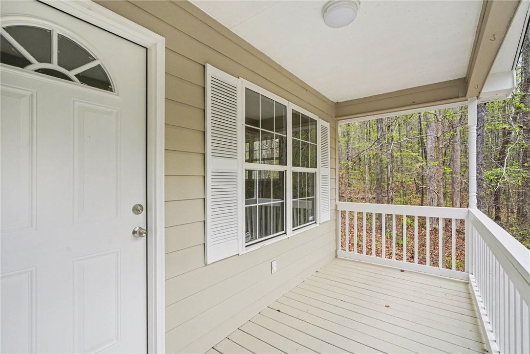 Image 2: This inviting covered porch provides a serene wood